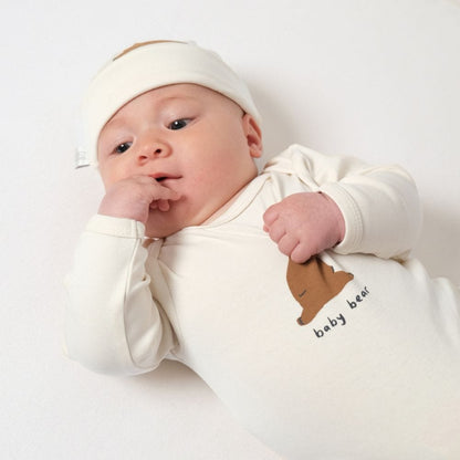 Cute baby wearing a chubby bear bodysuit and matching hat